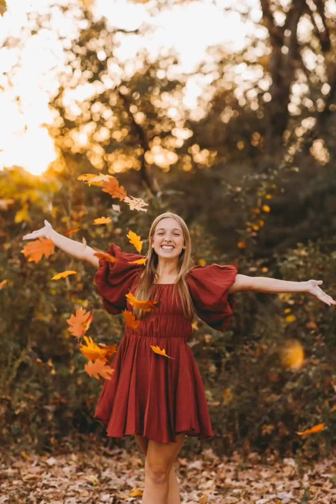 8. Rustic Red Dress In Falling Leaves